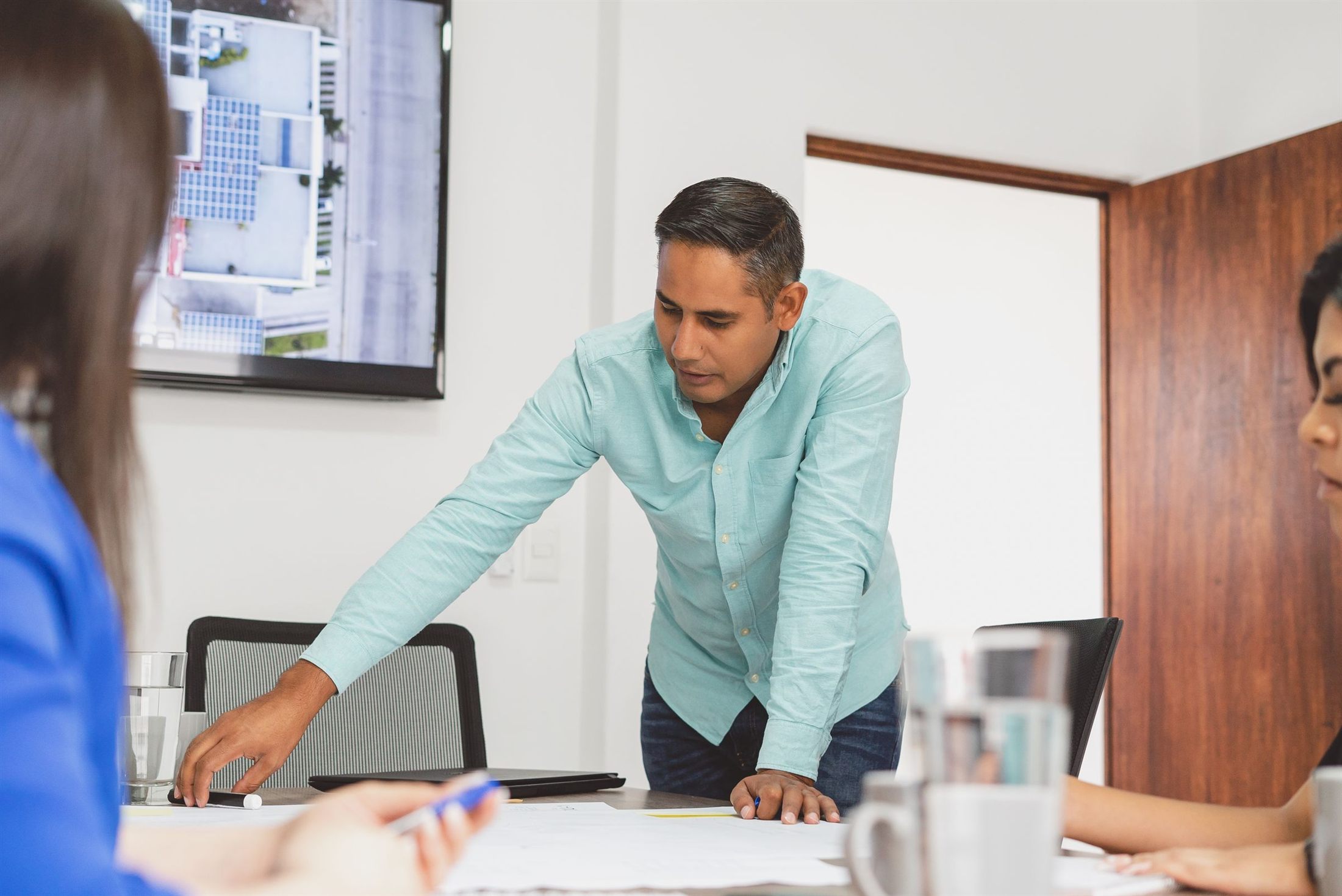 Indian executive leading a planning session with his team in a bright office