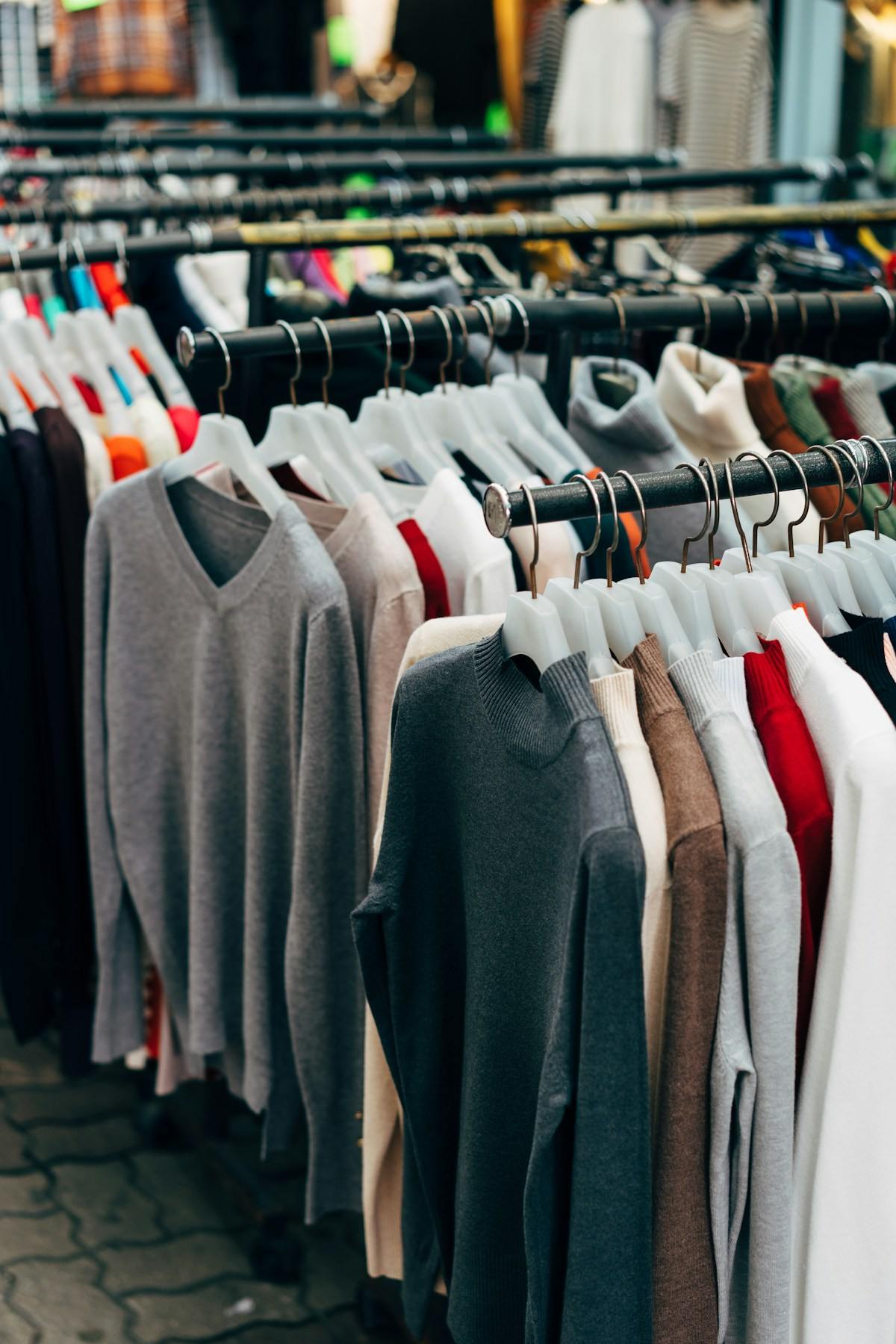 Rows of sweaters on a clothing rack