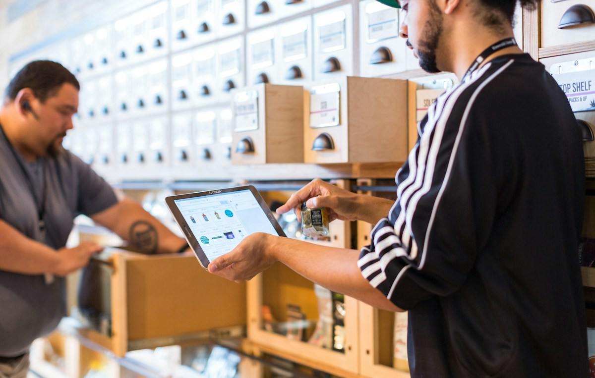 Store staff checking stock levels on a tablet