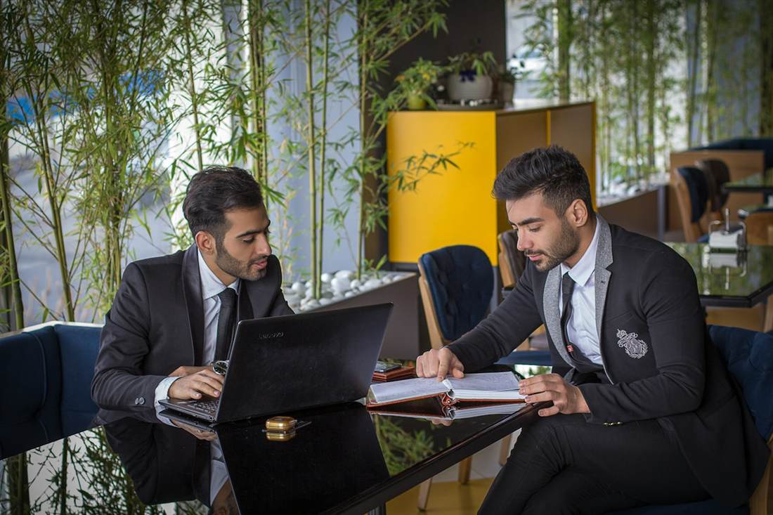 Two Indian executives reviewing deal documents together